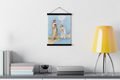 Baptism of Jesus print in a black magnetic bar hanger above a gray console with books and a yellow lamp