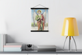 Saint Raphael the Archangel print in a black magnetic bar hanger above a console with a yellow lamp